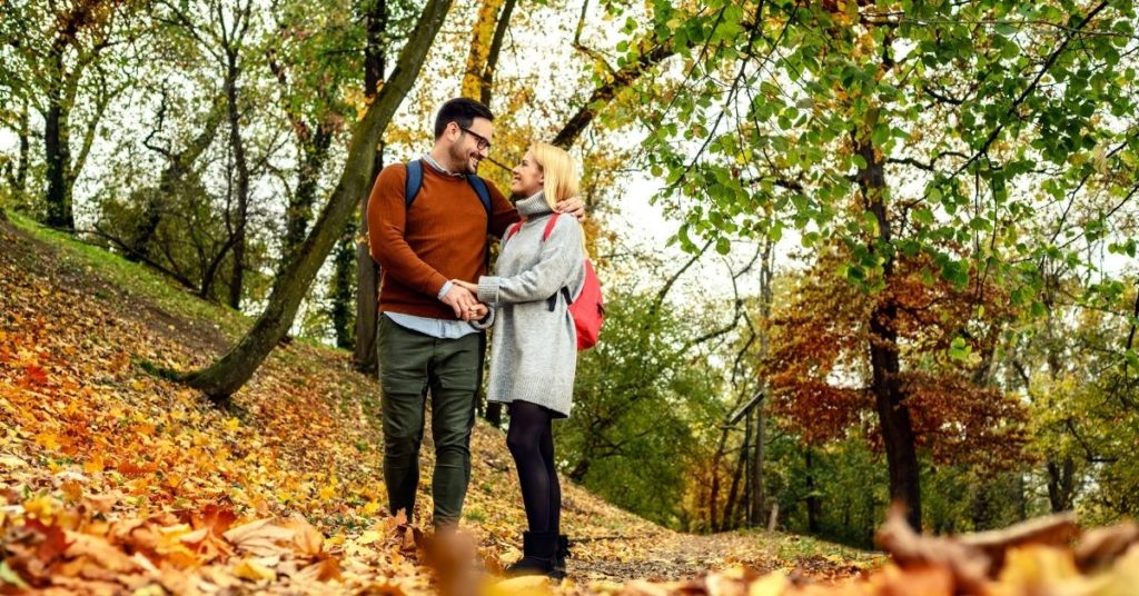 Couple walking in autumn park Neath