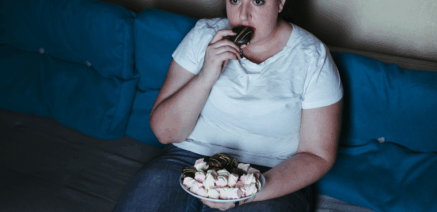 Person with chronic joint pain reaching for comfort food